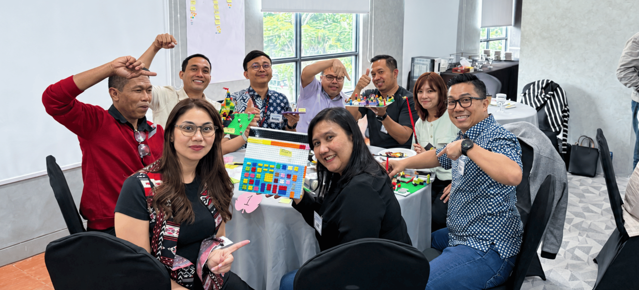 B-LOG team members raising their fists together during a team gathering